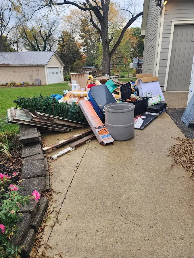 Dumpster being loaded with debris for Estate Cleanout Dumpster Rental in Bishop